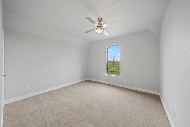 unfurnished room featuring lofted ceiling, light carpet, and ceiling fan