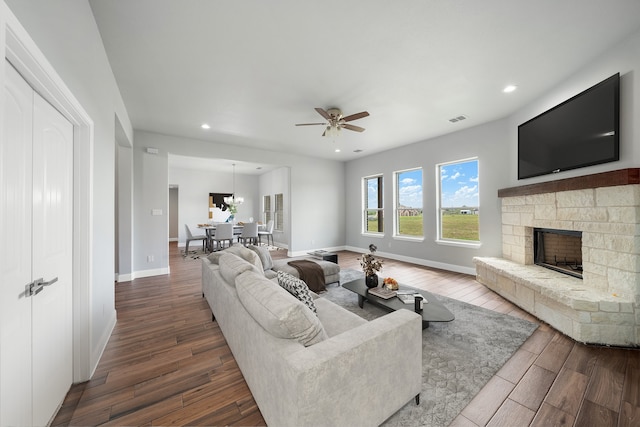 living room with hardwood / wood-style flooring, a fireplace, and ceiling fan