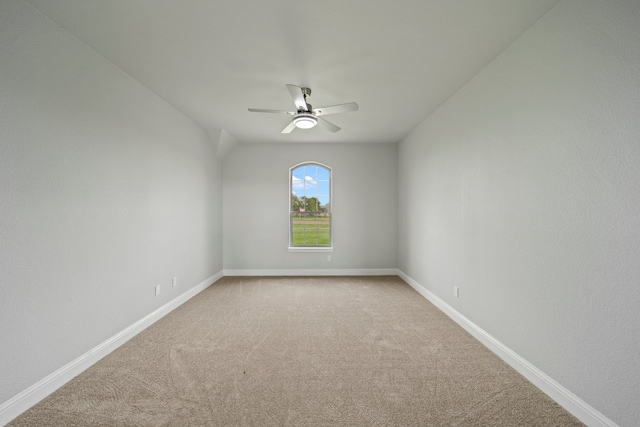 carpeted spare room featuring ceiling fan