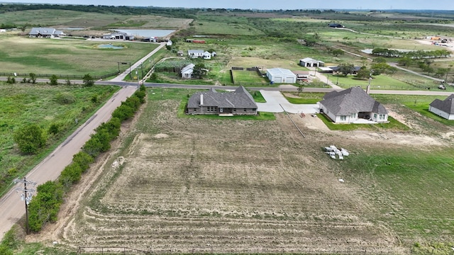 birds eye view of property with a rural view