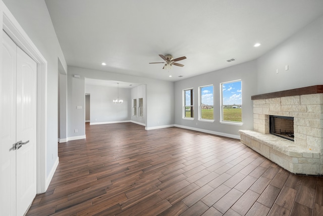 unfurnished living room with a fireplace, dark hardwood / wood-style floors, and ceiling fan with notable chandelier