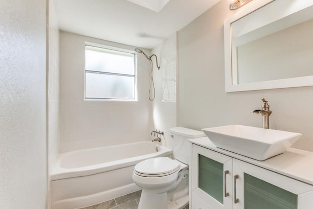 full bathroom featuring tile patterned floors, vanity, tiled shower / bath combo, and toilet