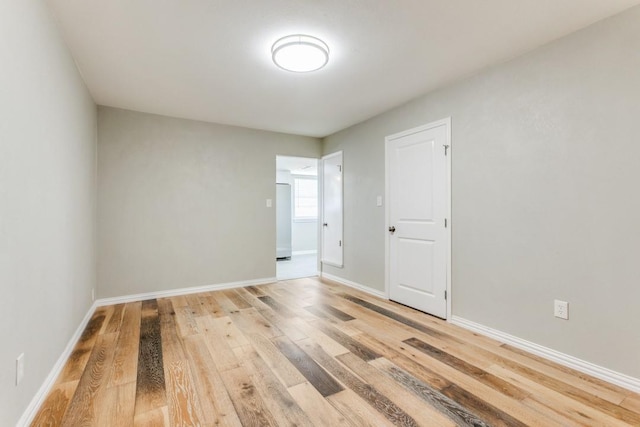 unfurnished room with hardwood / wood-style floors