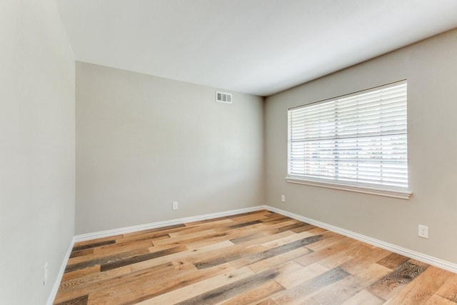 spare room with light hardwood / wood-style floors