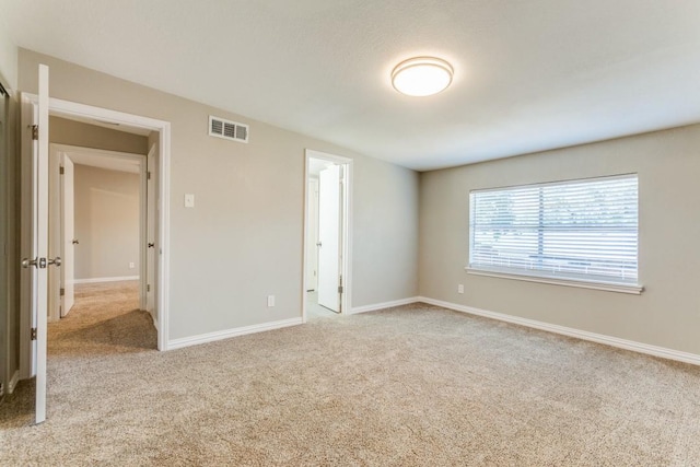 unfurnished bedroom featuring light carpet