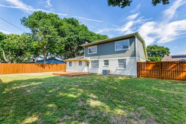 back of house with a yard and a deck