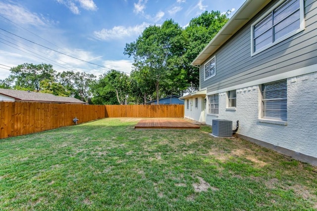 view of yard featuring central AC and a deck