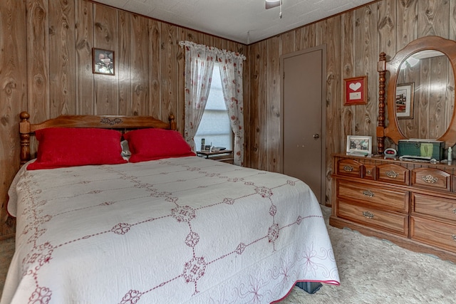 bedroom with wood walls, carpet, and ceiling fan