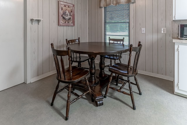 dining area featuring light carpet