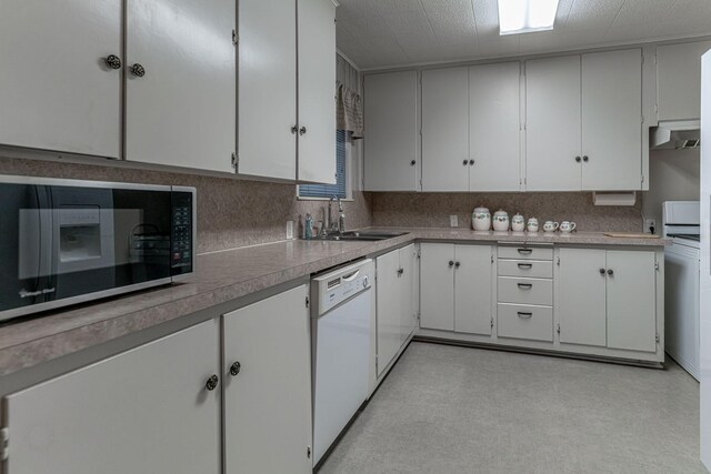 kitchen with white cabinetry, tasteful backsplash, ventilation hood, sink, and dishwasher