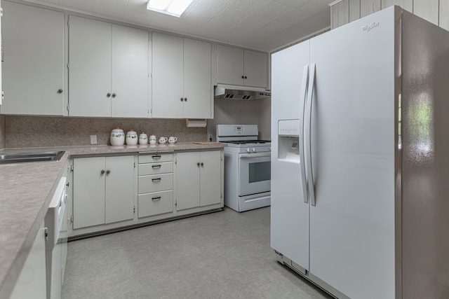 kitchen featuring sink, white cabinetry, and white appliances