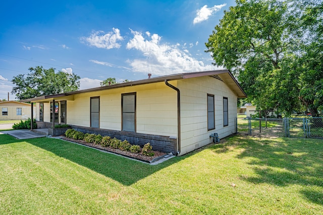 view of side of home with a lawn