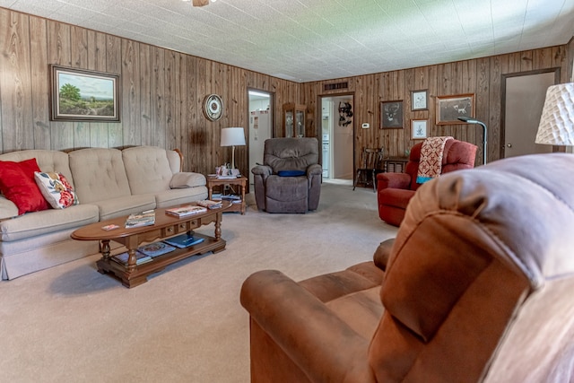 living room with carpet floors and wooden walls