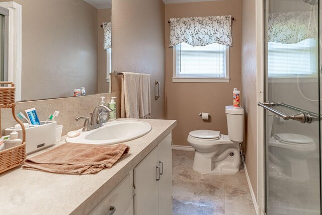 bathroom featuring vanity, tile patterned flooring, and toilet