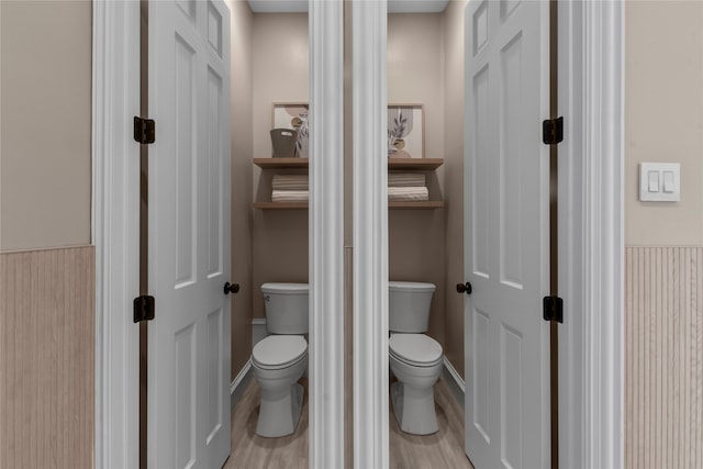 bathroom with toilet and wood-type flooring