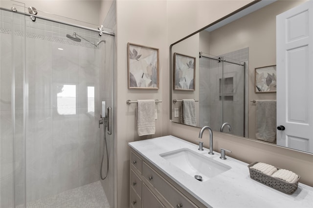 bathroom with an enclosed shower and vanity