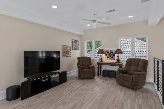 living room featuring ceiling fan and light wood-type flooring