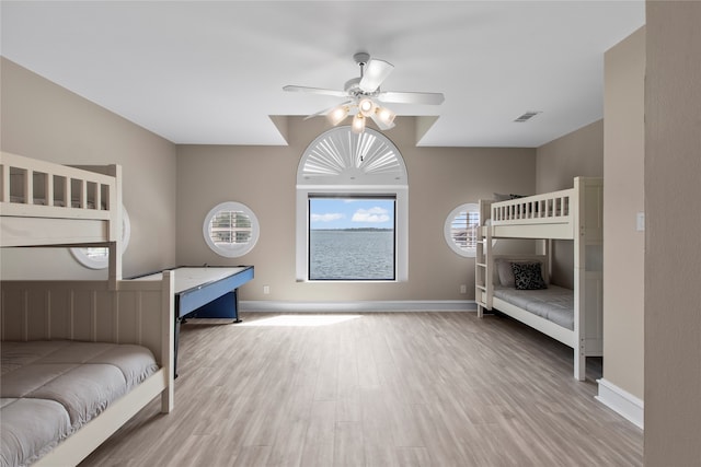 bedroom with ceiling fan and hardwood / wood-style flooring