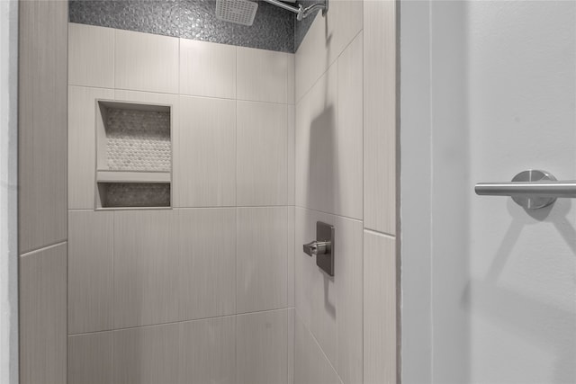 interior details with a tile shower