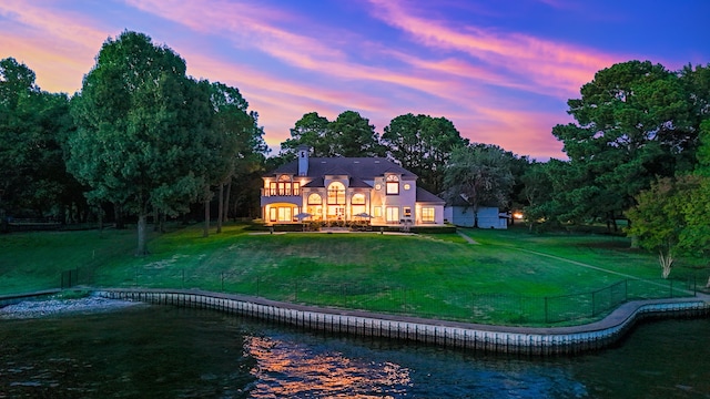 back house at dusk with a yard