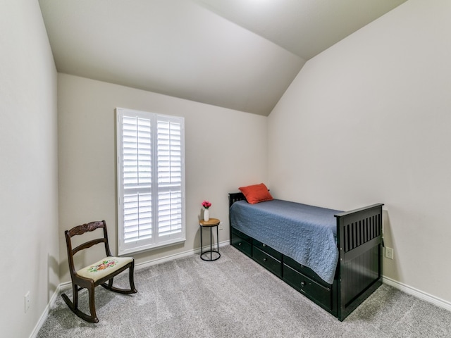 bedroom featuring lofted ceiling and light colored carpet