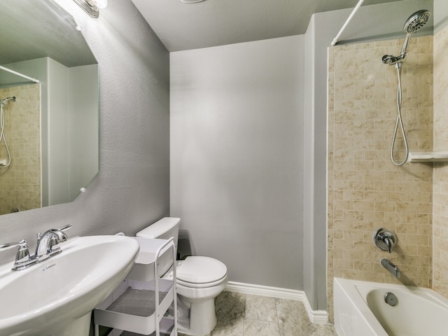 full bathroom with sink, tile patterned flooring, a textured ceiling, toilet, and tiled shower / bath combo