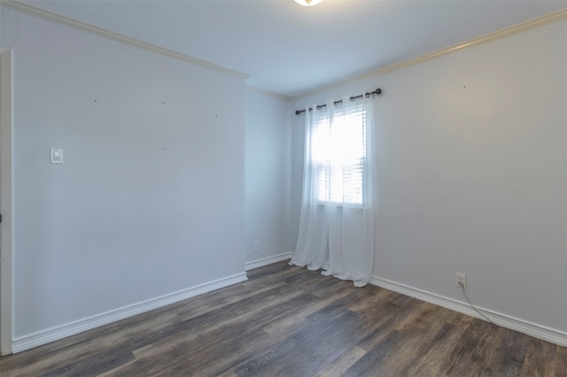 empty room featuring hardwood / wood-style flooring and ornamental molding