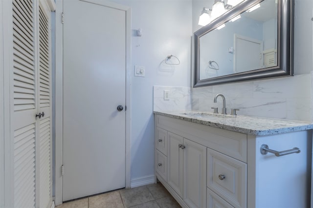 bathroom with tile patterned floors, tasteful backsplash, and vanity