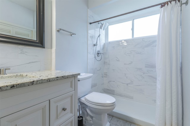 bathroom with tile patterned floors, vanity, tile walls, and toilet