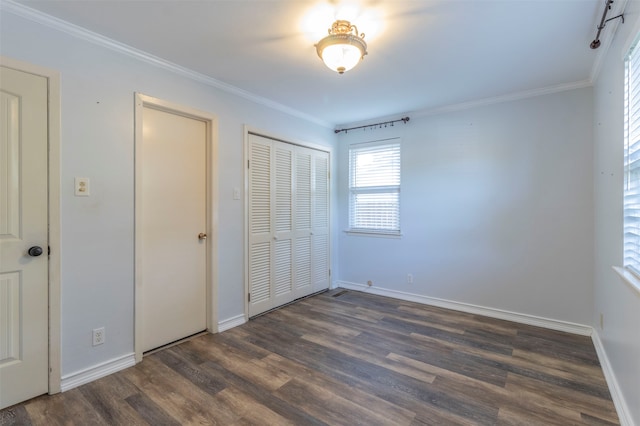 unfurnished bedroom featuring a closet, hardwood / wood-style flooring, and crown molding