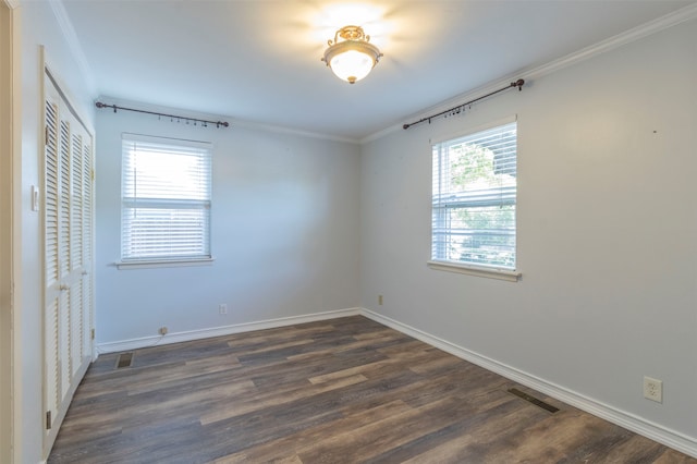 unfurnished bedroom with crown molding, a closet, and wood-type flooring