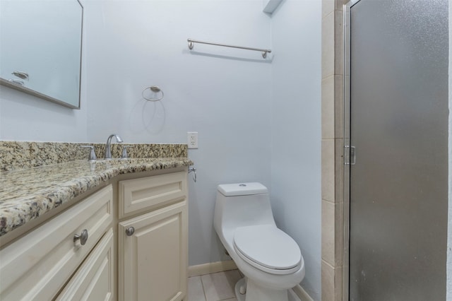 bathroom with a shower with door, toilet, and vanity