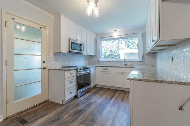 kitchen featuring white cabinetry, backsplash, dark hardwood / wood-style floors, light stone countertops, and appliances with stainless steel finishes