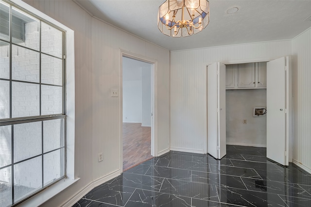 interior space with an inviting chandelier and a textured ceiling