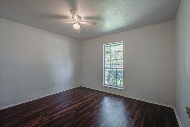 unfurnished room with dark hardwood / wood-style floors, a textured ceiling, and ceiling fan