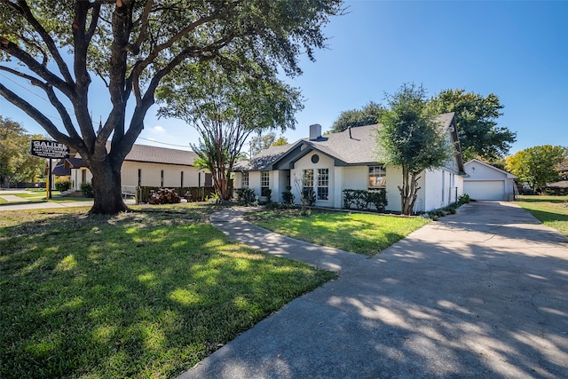 single story home with a front yard and a garage