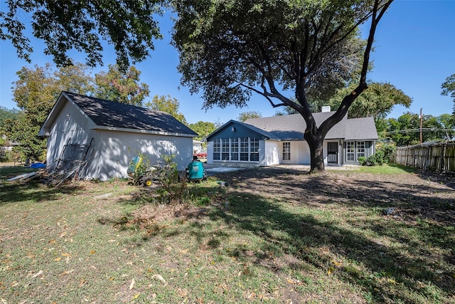 back of house with a lawn