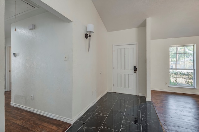 entryway featuring dark wood-type flooring and lofted ceiling