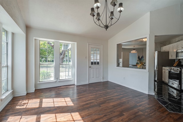 entryway featuring a textured ceiling, vaulted ceiling, plenty of natural light, and dark hardwood / wood-style floors