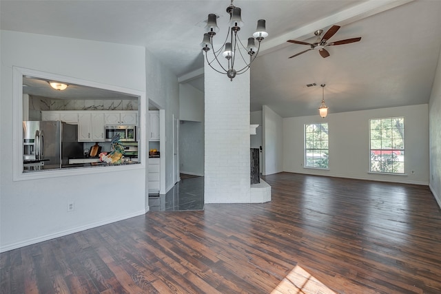 unfurnished living room with lofted ceiling with beams, dark hardwood / wood-style flooring, a fireplace, and ceiling fan with notable chandelier