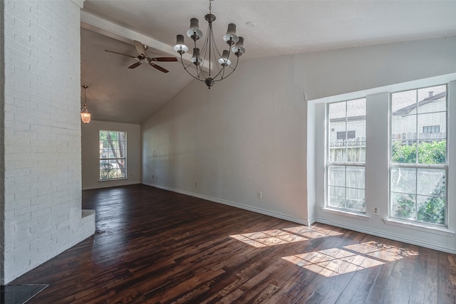 unfurnished dining area with ceiling fan with notable chandelier, lofted ceiling, and dark hardwood / wood-style floors