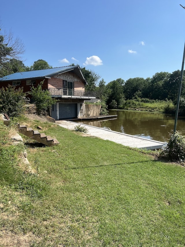 exterior space with a lawn and a water view