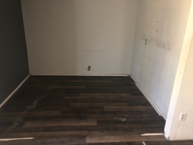 unfurnished room featuring dark wood-type flooring