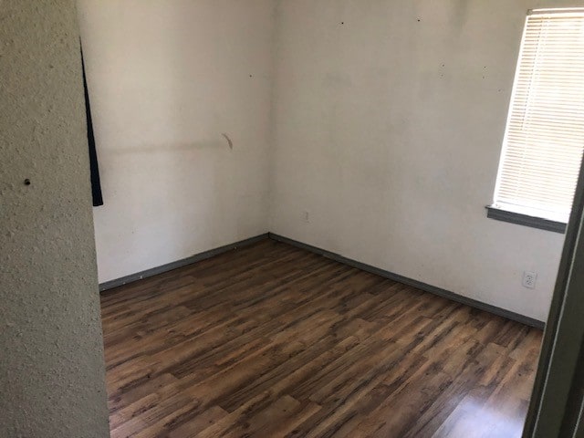 unfurnished room featuring hardwood / wood-style flooring