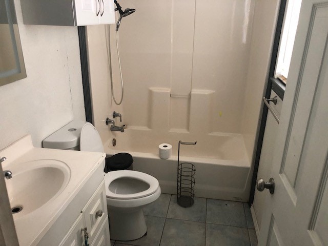 full bathroom with shower / bathtub combination, vanity, toilet, and tile patterned floors