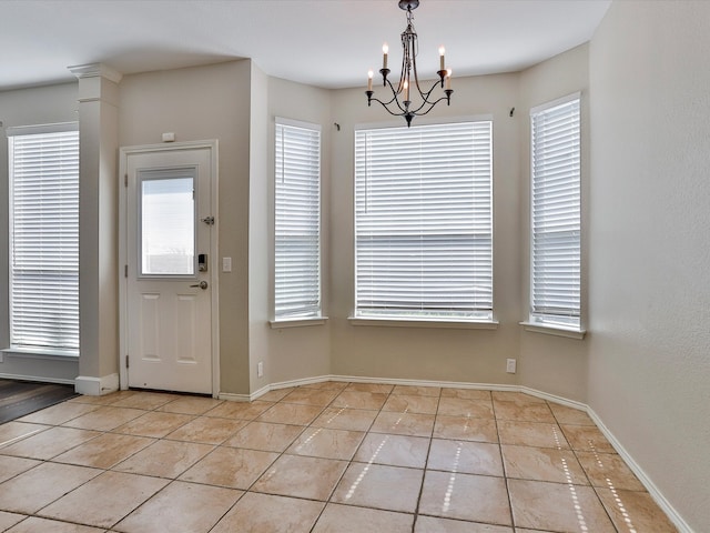 interior space featuring light tile patterned flooring and a chandelier