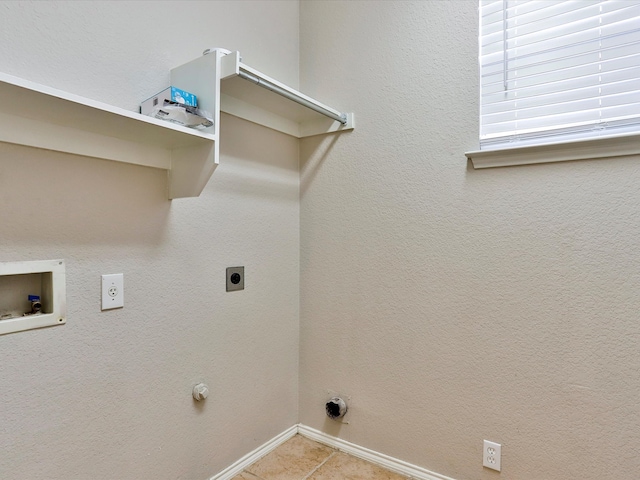 clothes washing area with washer hookup, light tile patterned flooring, gas dryer hookup, and hookup for an electric dryer