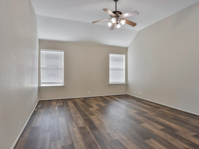 spare room with lofted ceiling, ceiling fan, and dark hardwood / wood-style flooring