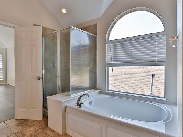 bathroom featuring lofted ceiling, shower with separate bathtub, and tile patterned floors