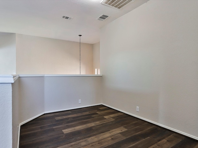 spare room with dark wood-type flooring